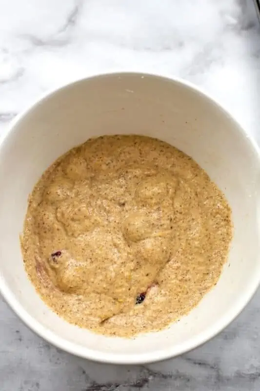 Healthy blackberry muffin batter after stirring in blackberries.