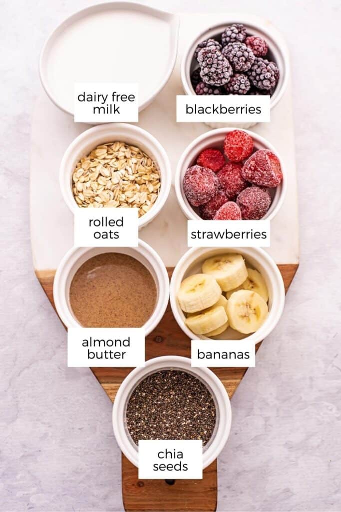 Ingredients to make strawberry blackberry banana smoothies in ramekins.