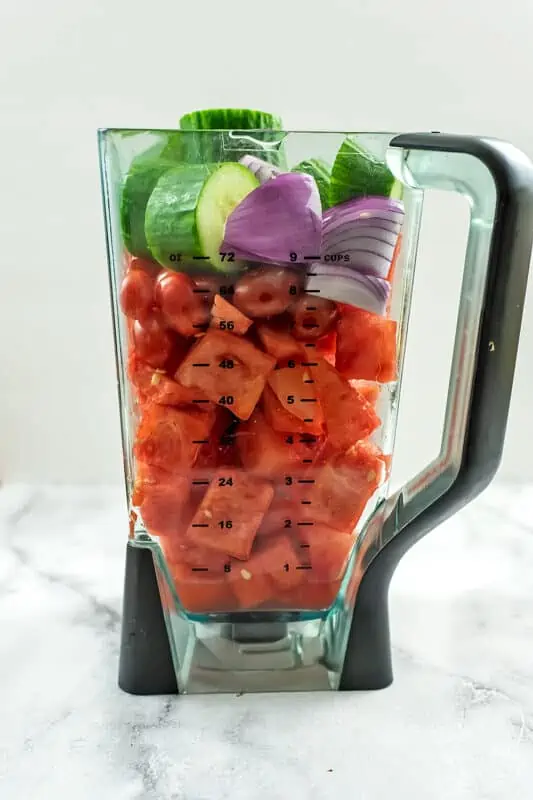 Watermelon tomato gazpacho ingredients in blender before blending.