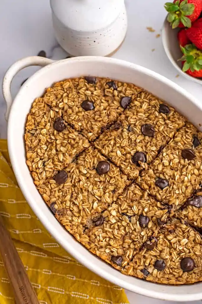 Chocolate chip baked oats in a casserole dish sliced into 8 bars.