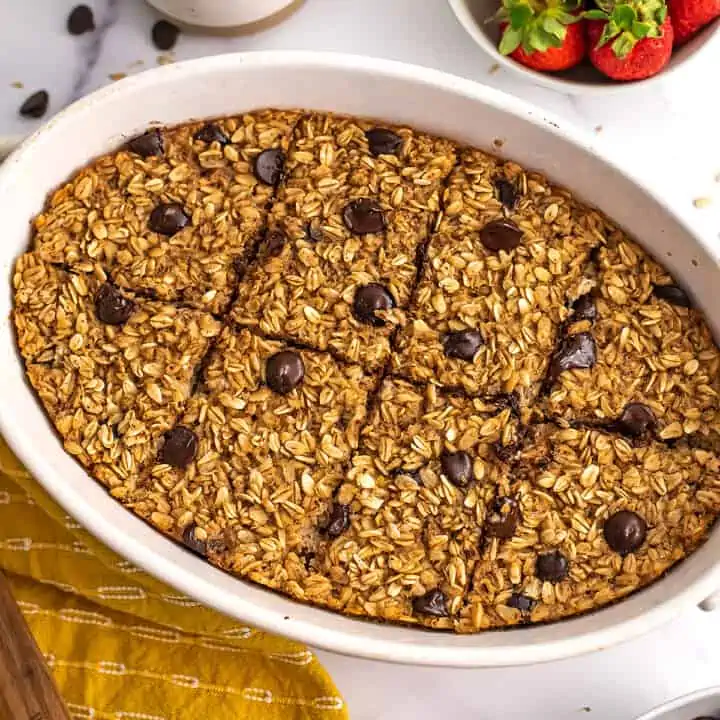 Chocolate chip baked oatmeal sliced into 8 pieces in casserole dish.