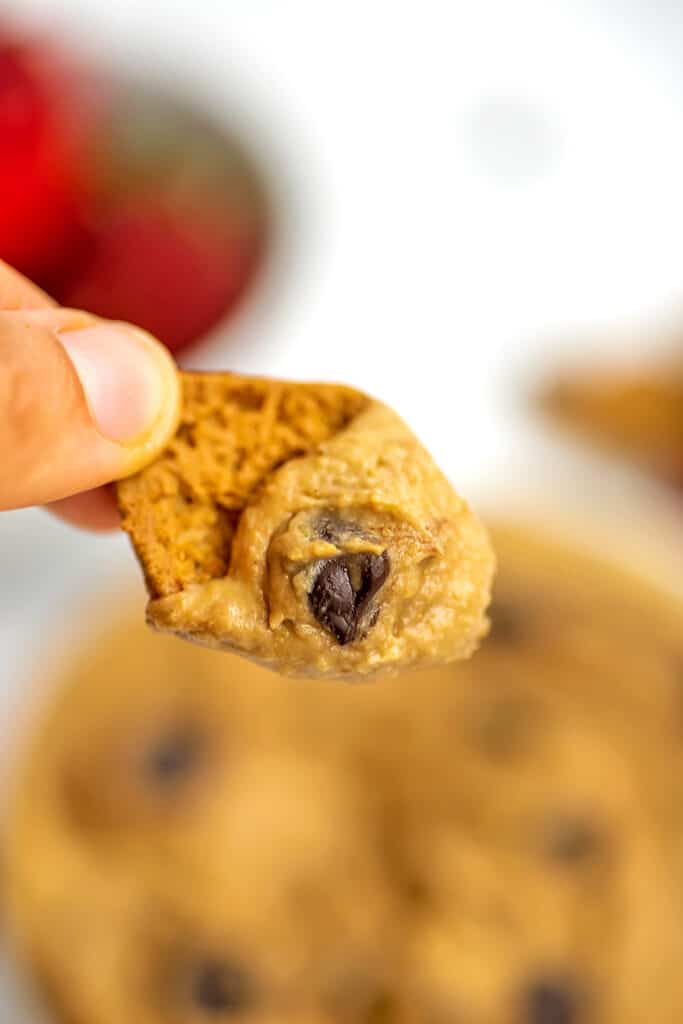 Cookie dipped in chickpea cookie dough dip.