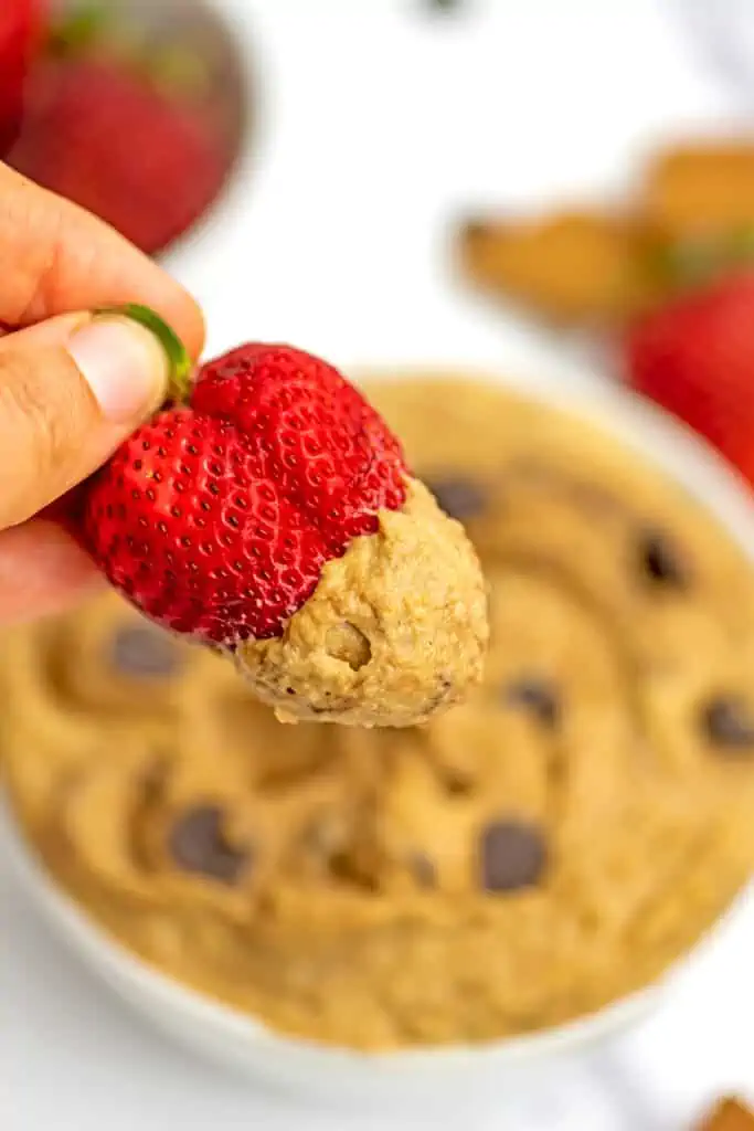Strawberry dipped in chocolate chip cookie dough hummus.