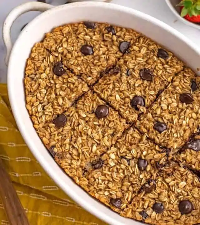 Chocolate chip baked oats in a casserole dish sliced into 8 bars.