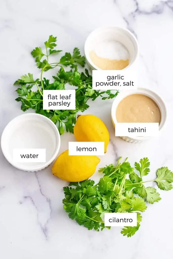 Ingredients to make lemon herb tahini in bowls.