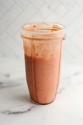Strawberry banana smoothie in a blender cup.