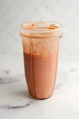 Strawberry banana smoothie in a blender cup.