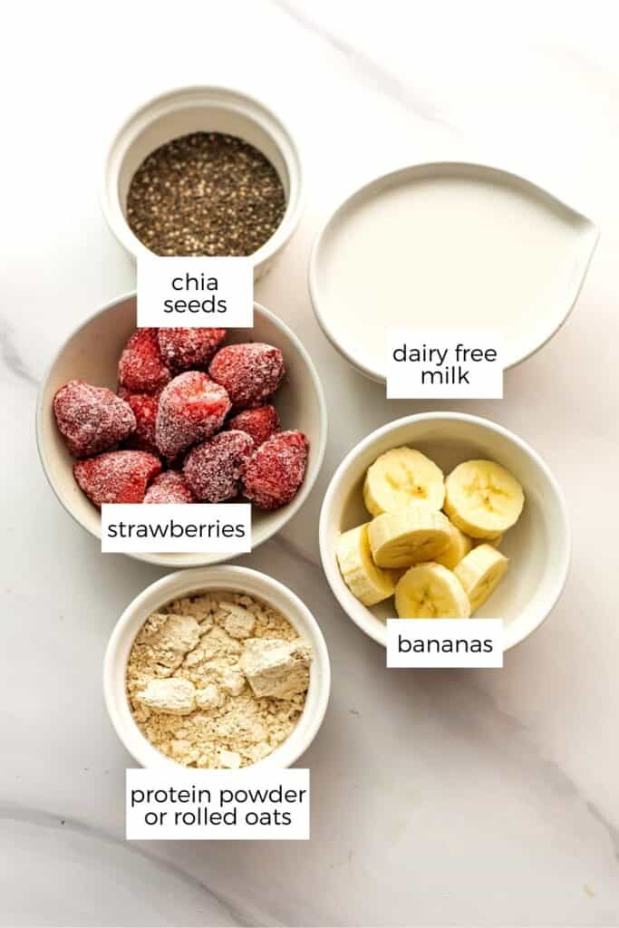 Ingredients to make strawberry banana smoothies in ramekins.