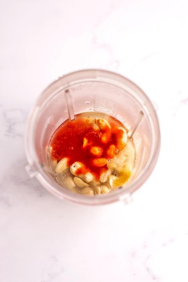 Cashews and hot sauce in a blender.