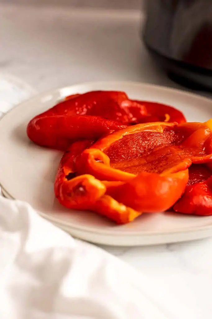 Air fryer roasted red peppers on a white plate.