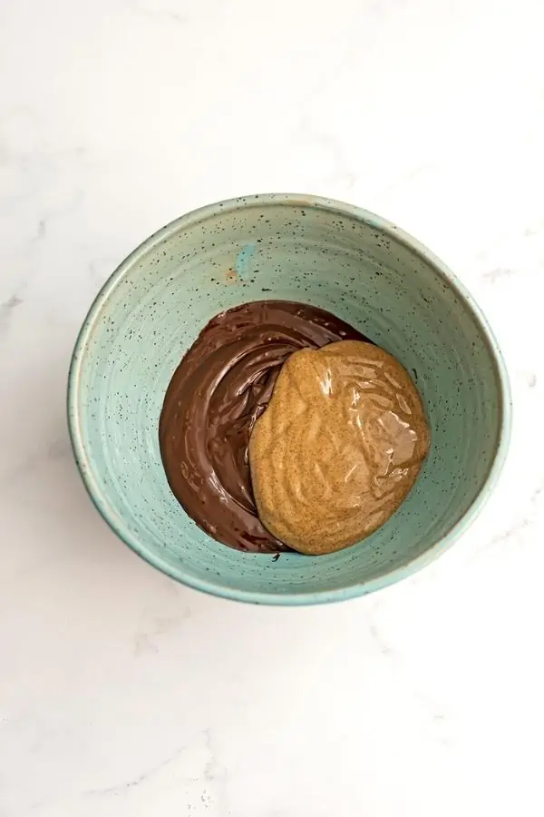Blue bowl filled with melted chocolate and almond butter.