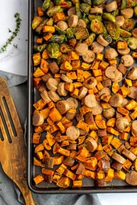 Chicken apple sausage sheet pan dinner on baking sheet.