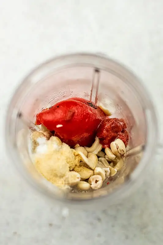 Blender with roasted red peppers, cashews, salt, garlic, tomato paste.