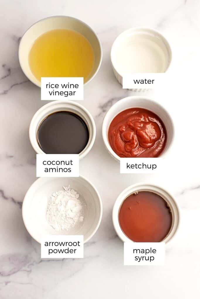 Ingredients to make vegan sweet and sour sauce on a marble countertop.