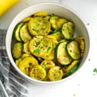 Air fryer zucchini and squash in white bowl.