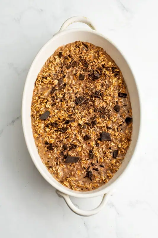 Casserole dish filled with chocolate oatmeal before baking.