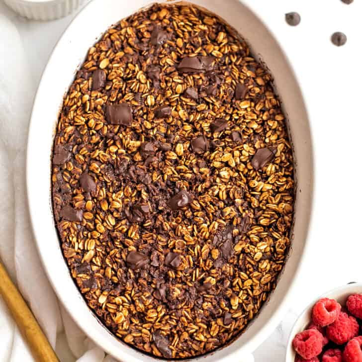 White casserole dish filled with baked chocolate oatmeal.