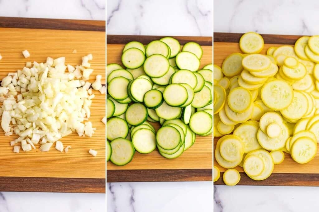 Chopped onion, sliced zucchini and sliced yellow squash on wooden cutting board.