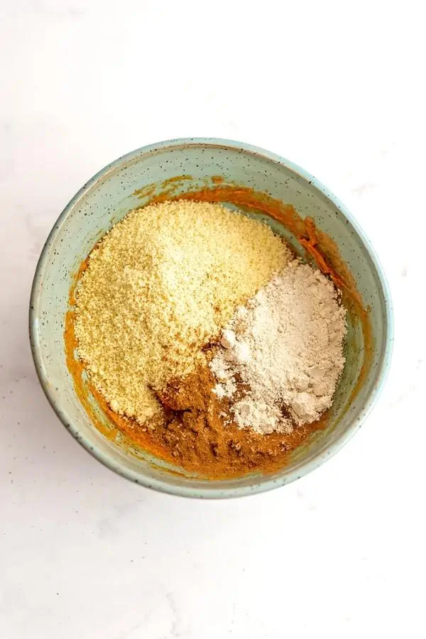 Almond flour, oat flour and spices in green bowl.