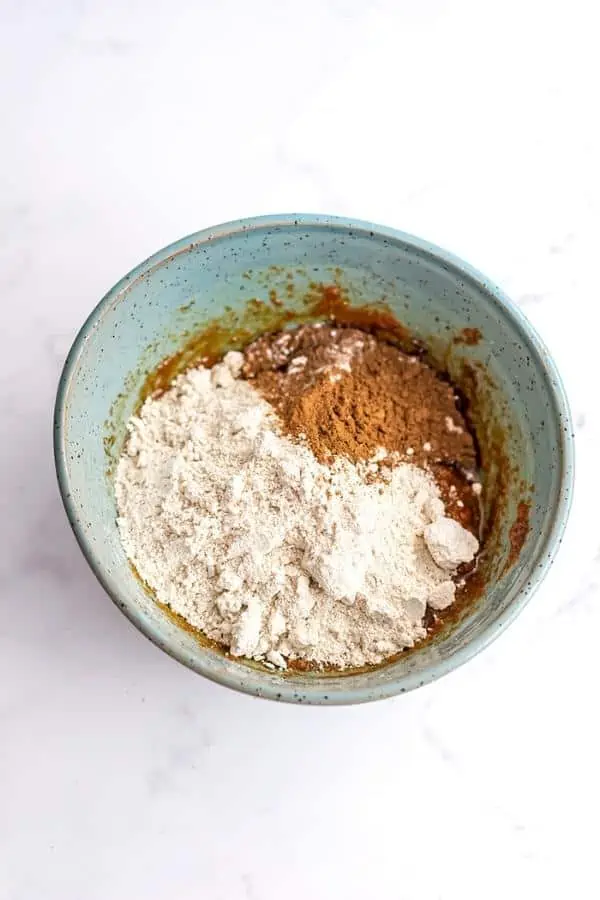 Oat flour and spices in a blue bowl.
