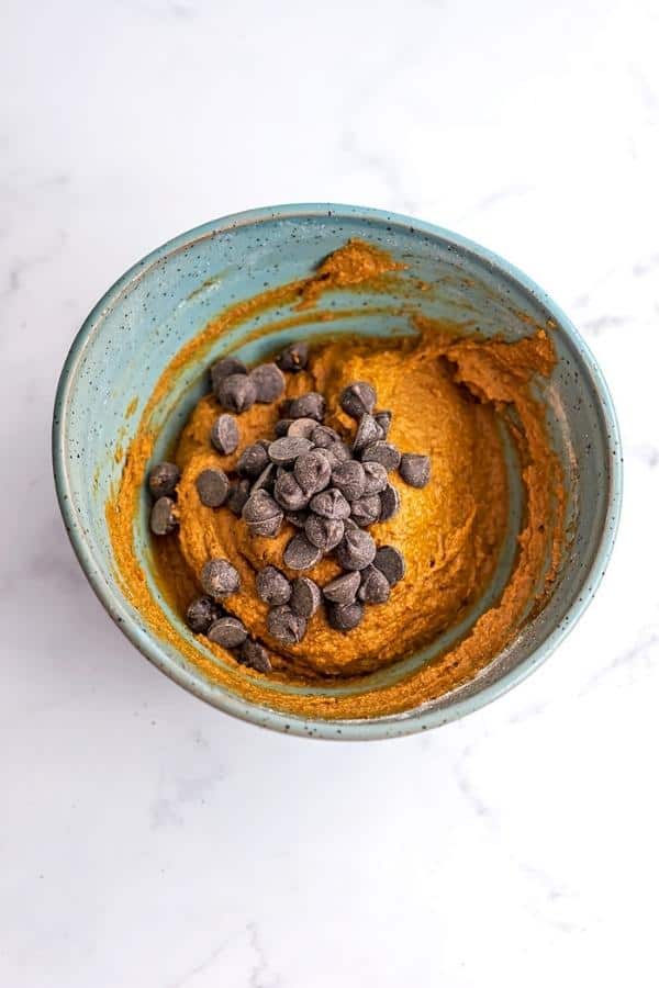 Chocolate chips added to pumpkin cookie dough.