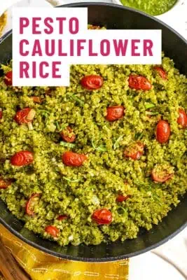 Large cast iron skillet filled with pesto cauliflower rice.