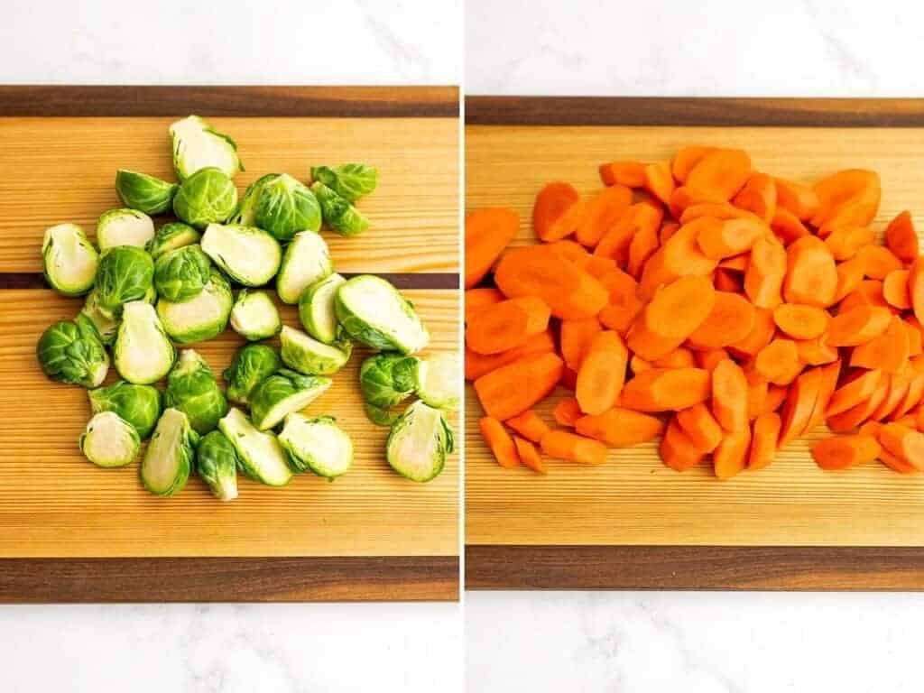 Chopped brussel sprouts and thinly cut carrots on a wooden cutting board.