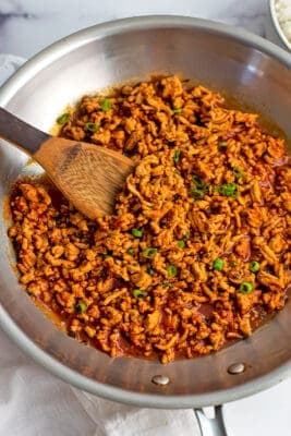 Ground chicken sloppy joes in a stainless steel skillet.