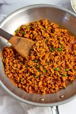Ground chicken sloppy joes in a stainless steel skillet.