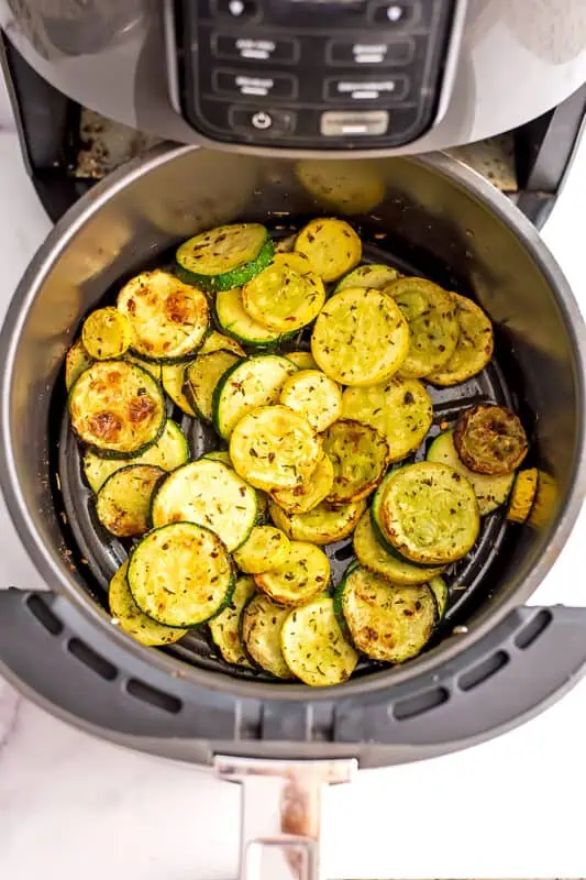 Zucchini and yellow squash in air fryer after cooking.