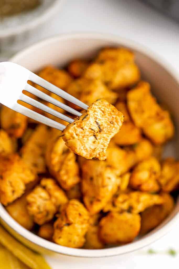 Fork holding a single air fryer chicken bites.