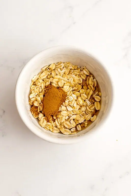 Rolled oats and cinnamon in a ramekin.