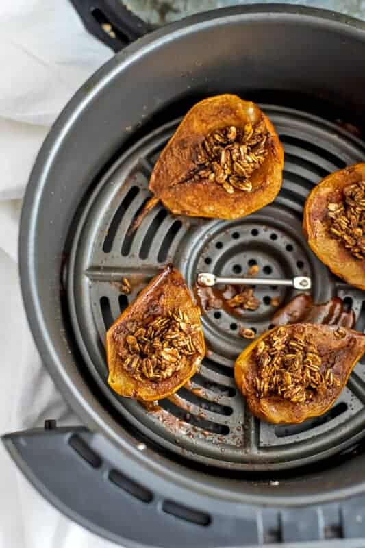 Pear crumble in an air fryer basket.