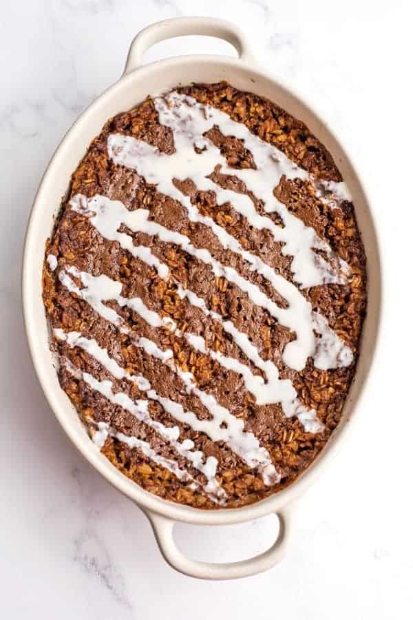 Coconut butter drizzled on top of cinnamon roll baked oatmeal.