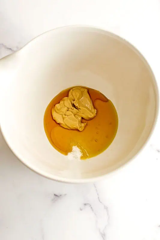 Dijon mustard, maple syrup and olive oil in a large mixing bowl.