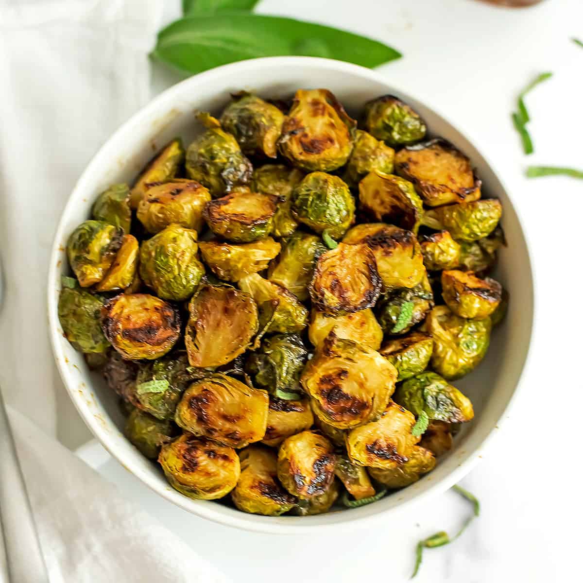 Maple dijon mustard brussel sprouts in a white bowl.