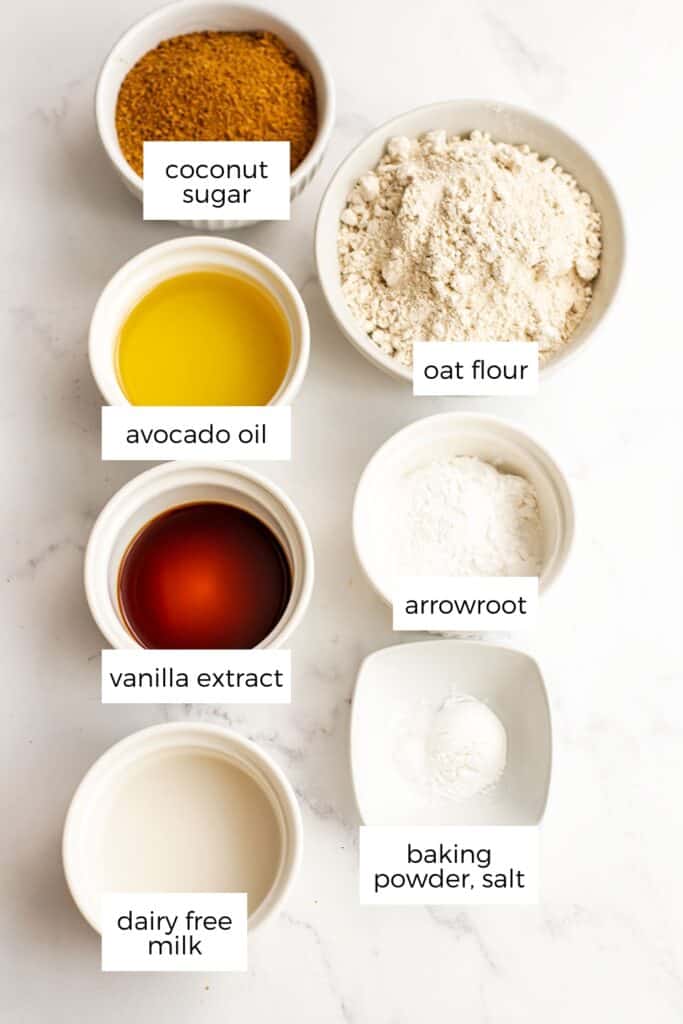 Ingredients to make oat flour sugar cookies in white bowls.