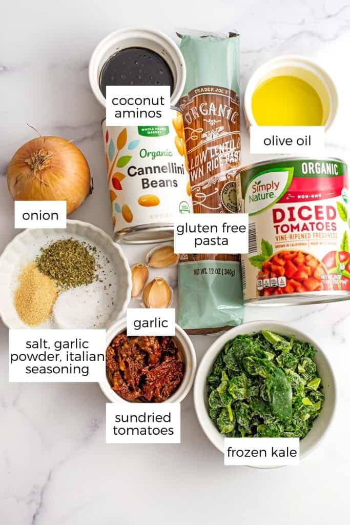 Ingredients to make this vegan white bean pasta in ramekins on marble countertop.