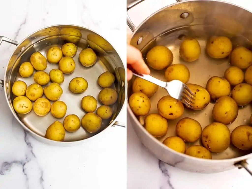 Potatoes in a stainless steel pot before boiling and with a fork being stuck in it.