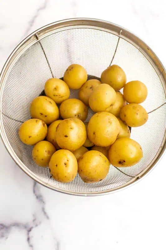Baby potatoes in a mesh strainer.