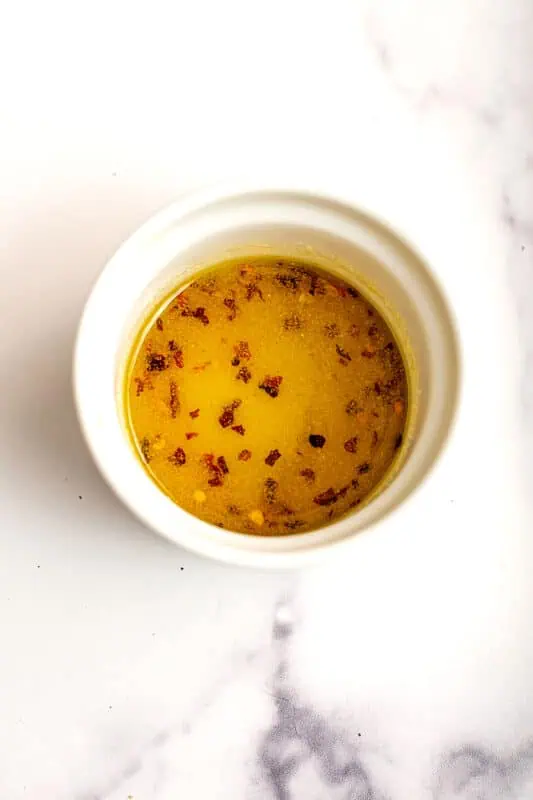 Olive oil and spices in a ramekin.
