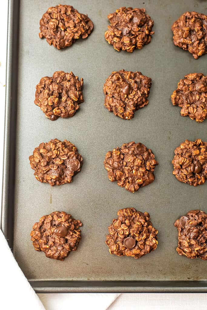 Vegan chocolate oatmeal cookies on a baking sheet.
