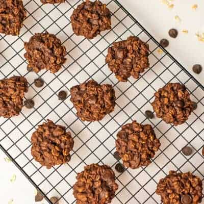 Vegan chocolate oatmeal cookies on a black cooling rack.