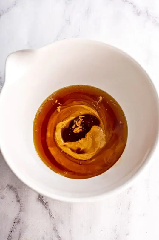 Peanut butter, maple syrup and vanilla added to a large bowl.