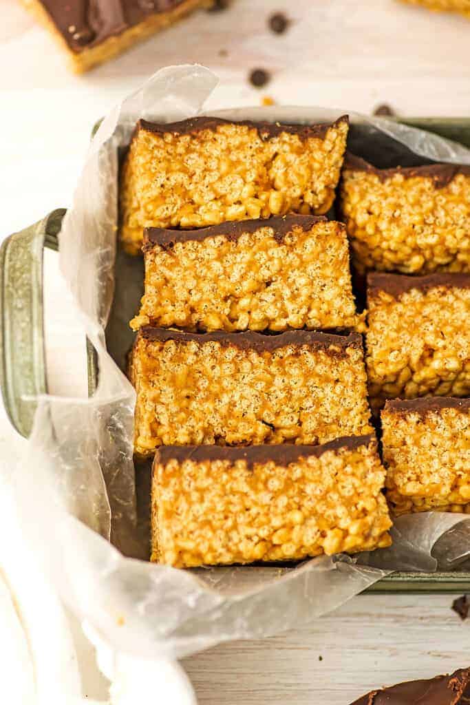 Chocolate peanut butter rice krispy treats (no marshmallow) in a metal tray lined with wax paper.