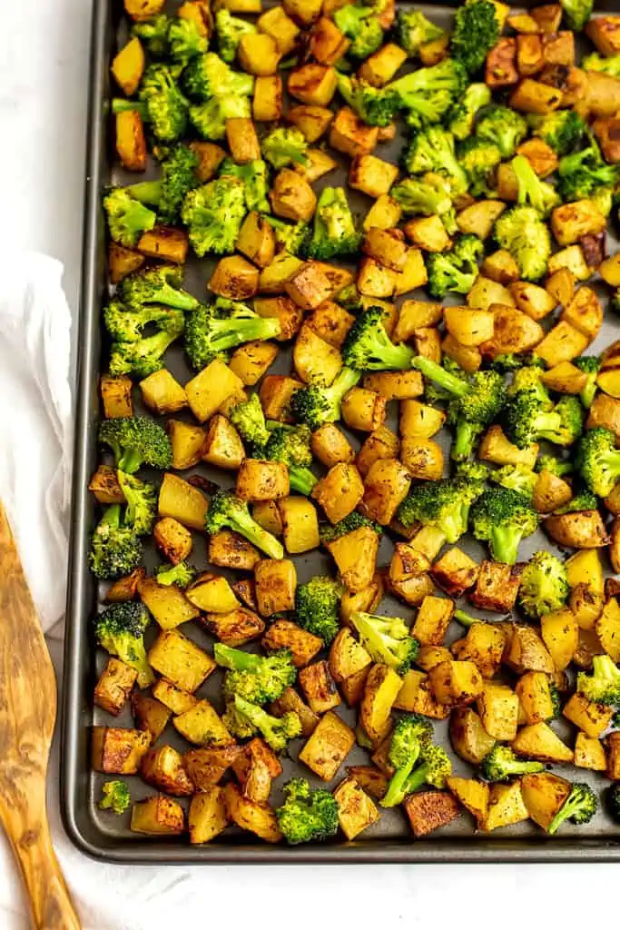 Roasted potatoes and broccoli in a sheet pan.