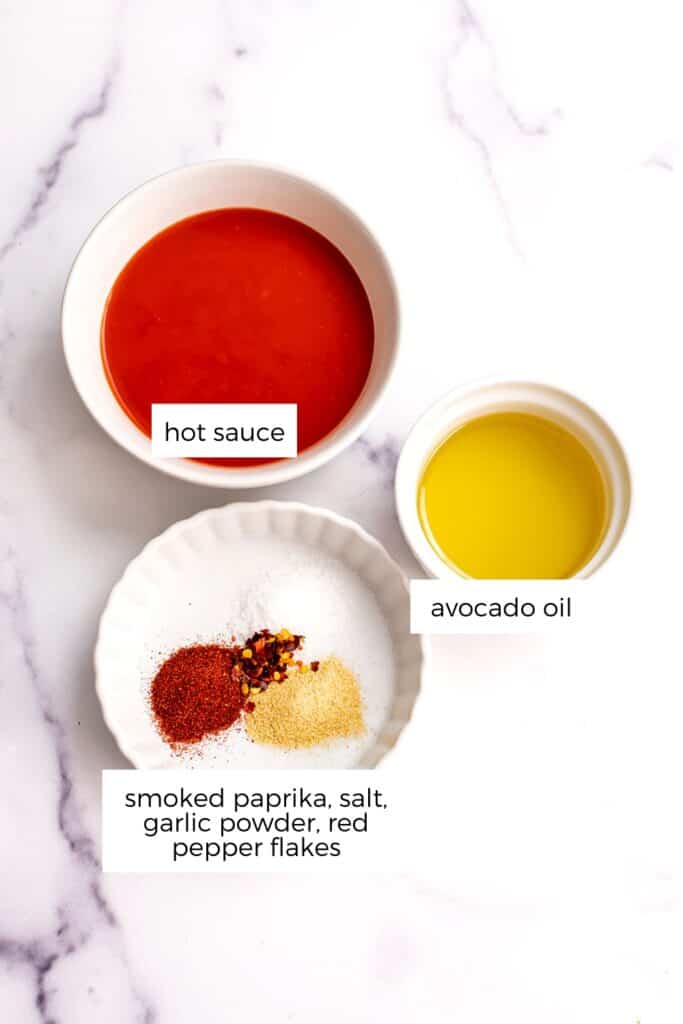 Ingredients to make vegan buffalo sauce in white bowls.