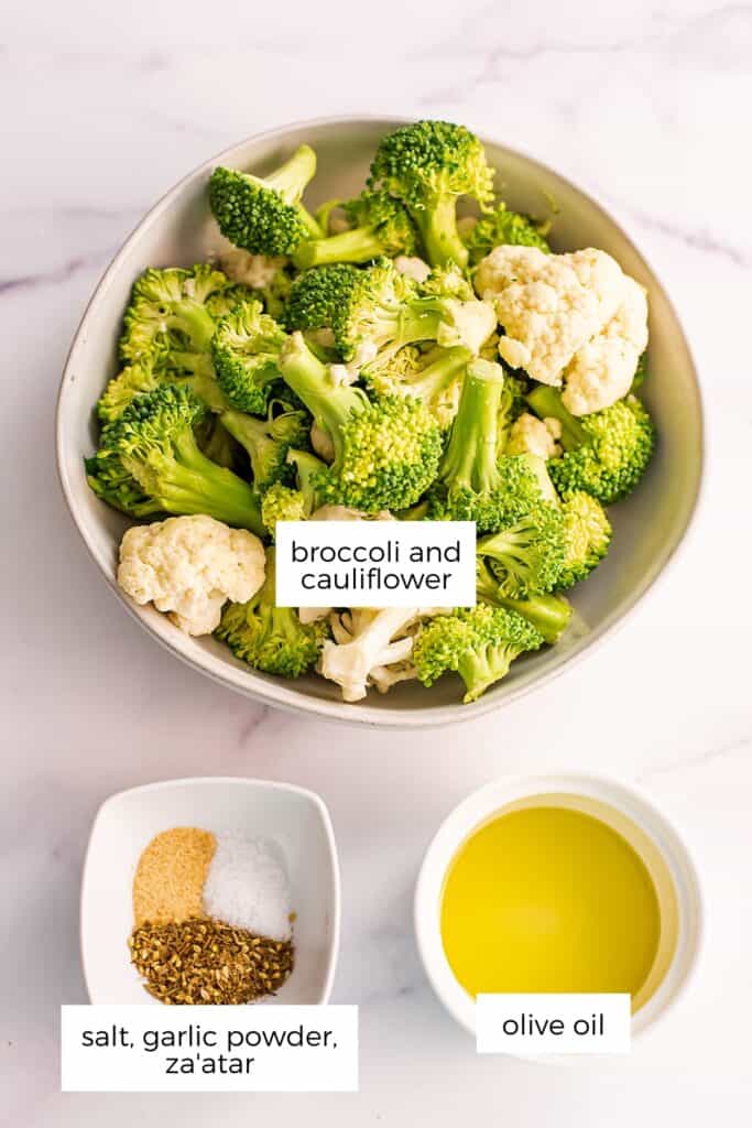 Ingredients to make air fryer broccoli and cauliflower in white bowls.