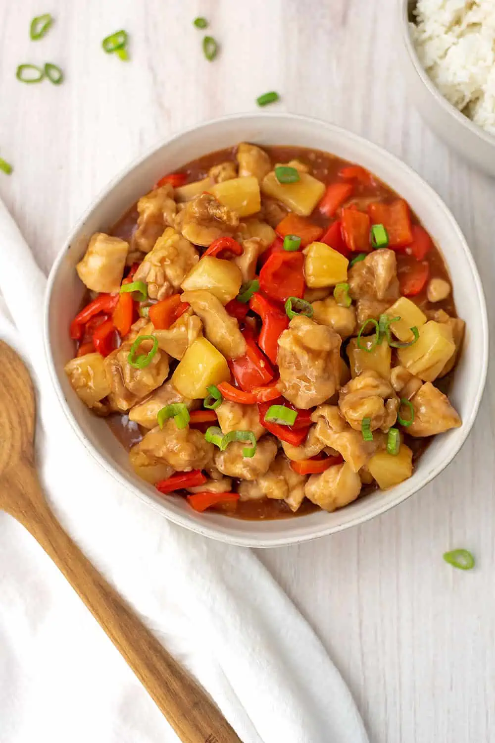 Sweet and sour chicken cooked in air fryer in a large white bowl.
