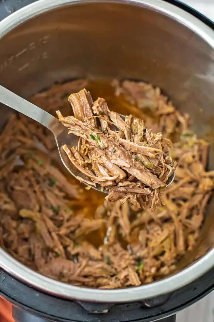 Large spoonful of instant pot shredded beef.